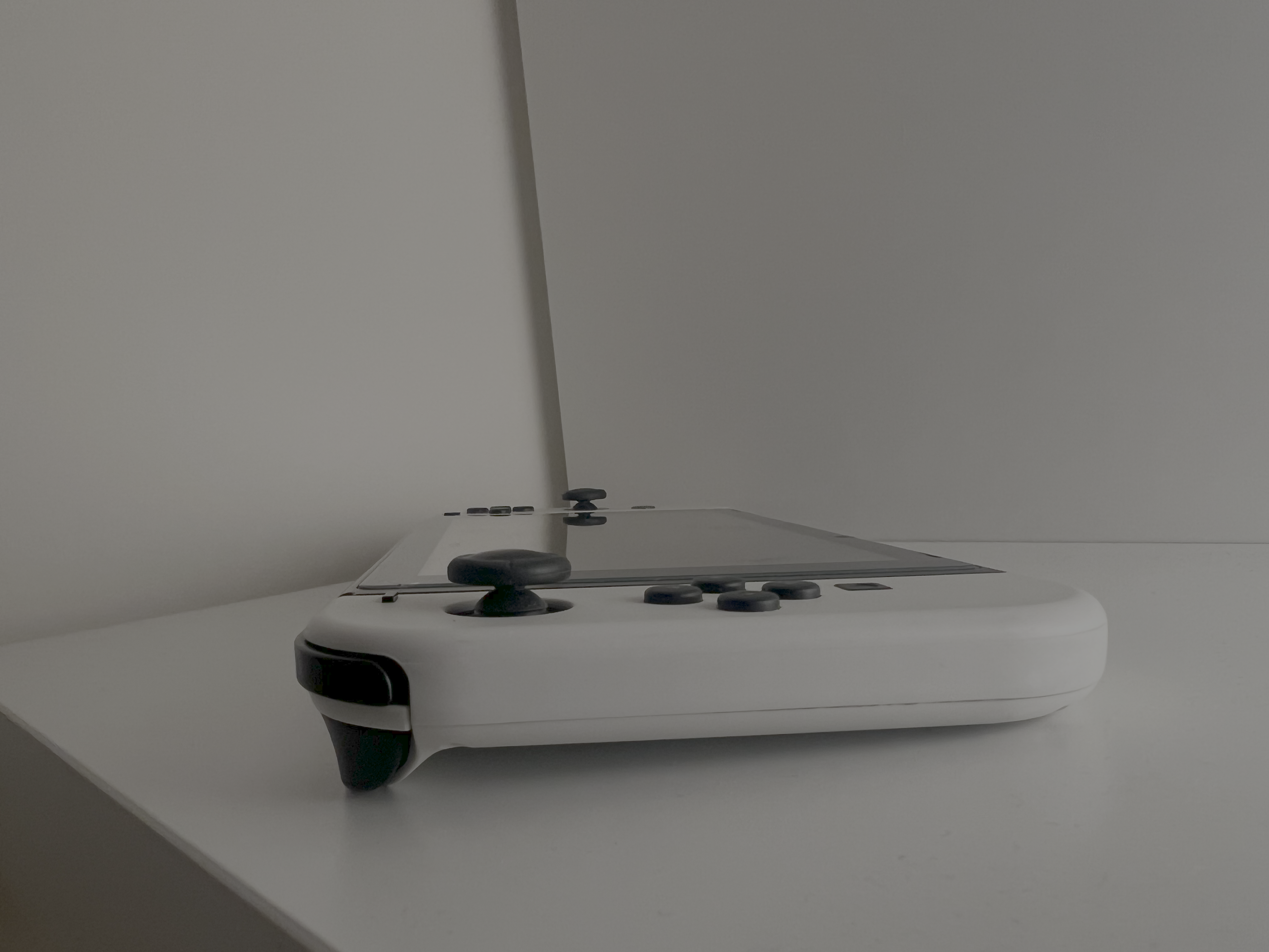 Chosen to highlight how the side buttons and joysticks protrude from the Joy-Con. This profile view makes the thickness and curve of the edges visible.